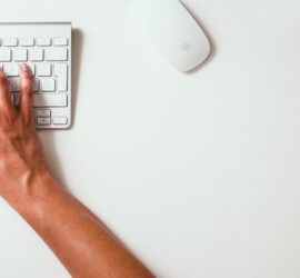 person typing on Apple Cordless Keyboard