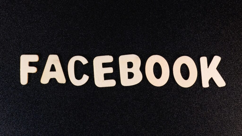 the word facebook spelled with white letters on a black background